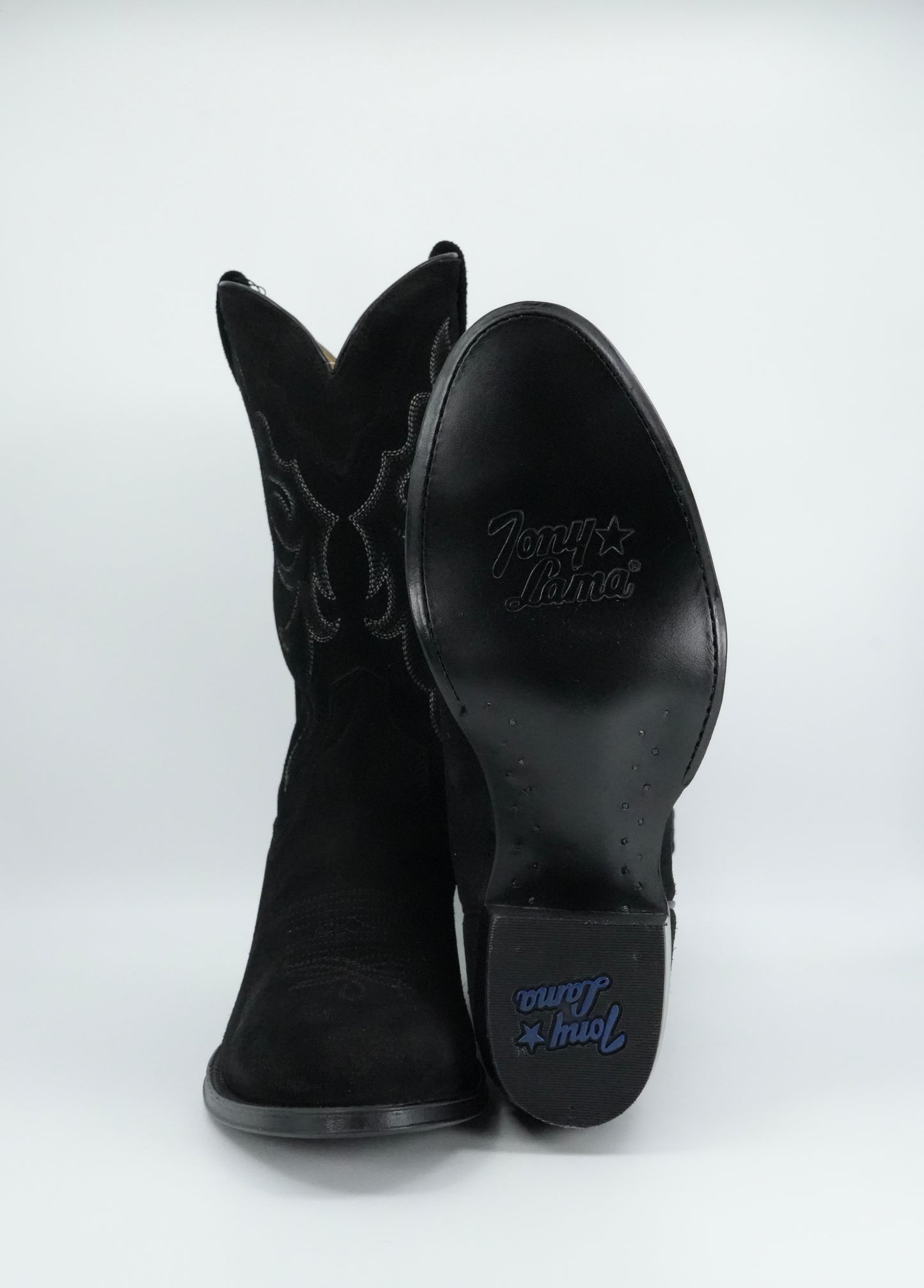 Black cowboy boots with brand logo on a white background